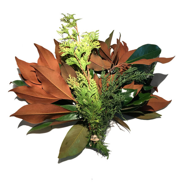 A lush bouquet of magnolia leaves, ferns, and greenery arranged for decorative display.