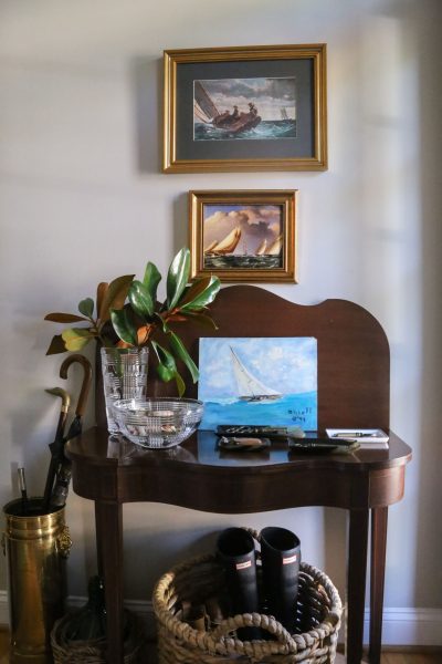 Cozy indoor scene with nautical-themed artwork and houseplants at Weston Farms.