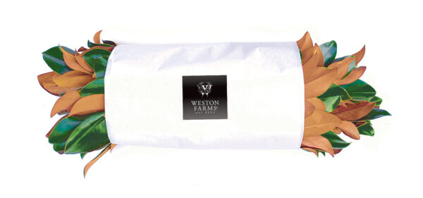 Fresh Weston Farms produce wrapped in white paper with the Weston Farms logo, showcasing farm-fresh.