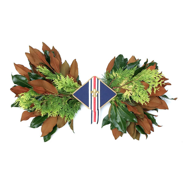Celebration award with green and brown foliage, and a blue ribbon with red, white, and blue stripes.