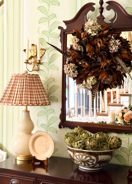 Elegant fall blush wreath with flowers and leaves on a vintage mirror.