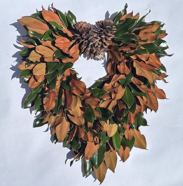 Bright autumn leaf heart wreath with pinecones, perfect for seasonal decor and festive celebrations.