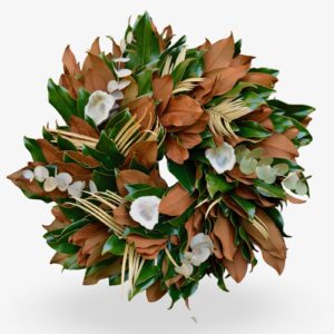 Soft magnolia and greenery wreath with cotton accents, ideal for home decor and seasonal decorations.